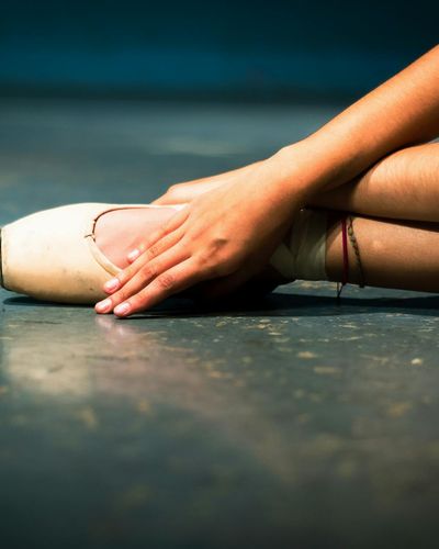 Close-up of hands and feet placement during a floor exercise.