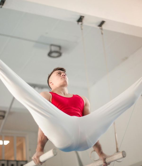 Man performing a controlled strength exercise in a minimalist gym.
